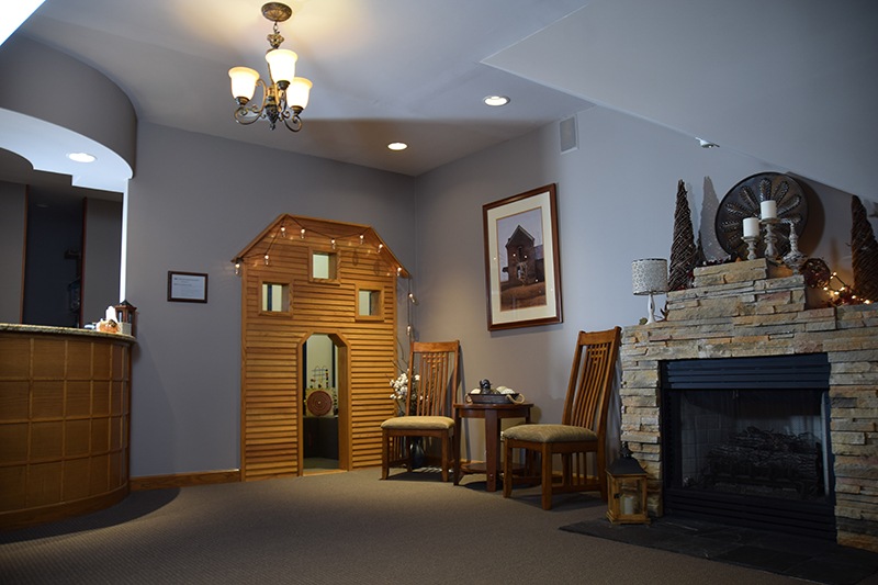 front office with fireplace, chairs and decorations