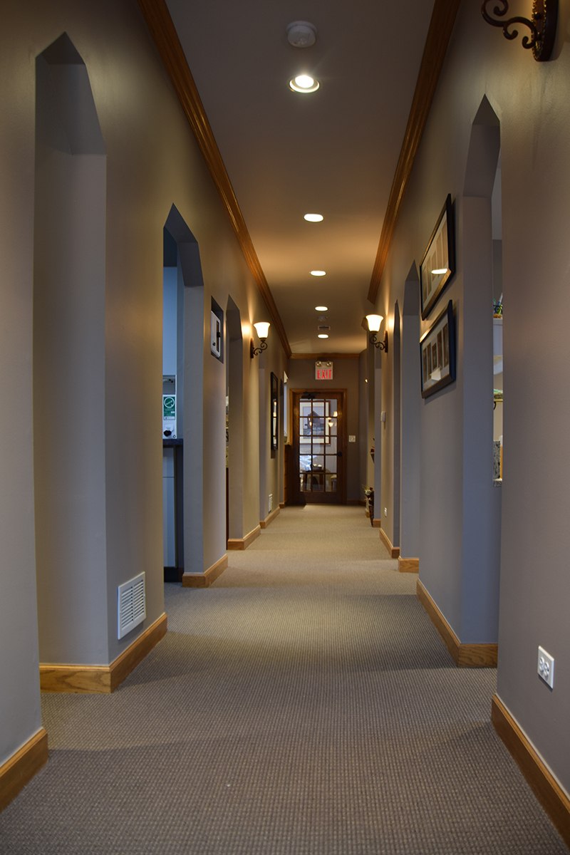 hallway in back office with entryways to treatment areas