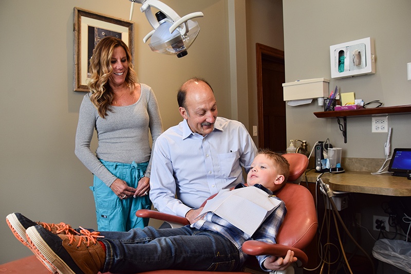 Dr. Peter Lo Destro and staff with little boy in the dental chair